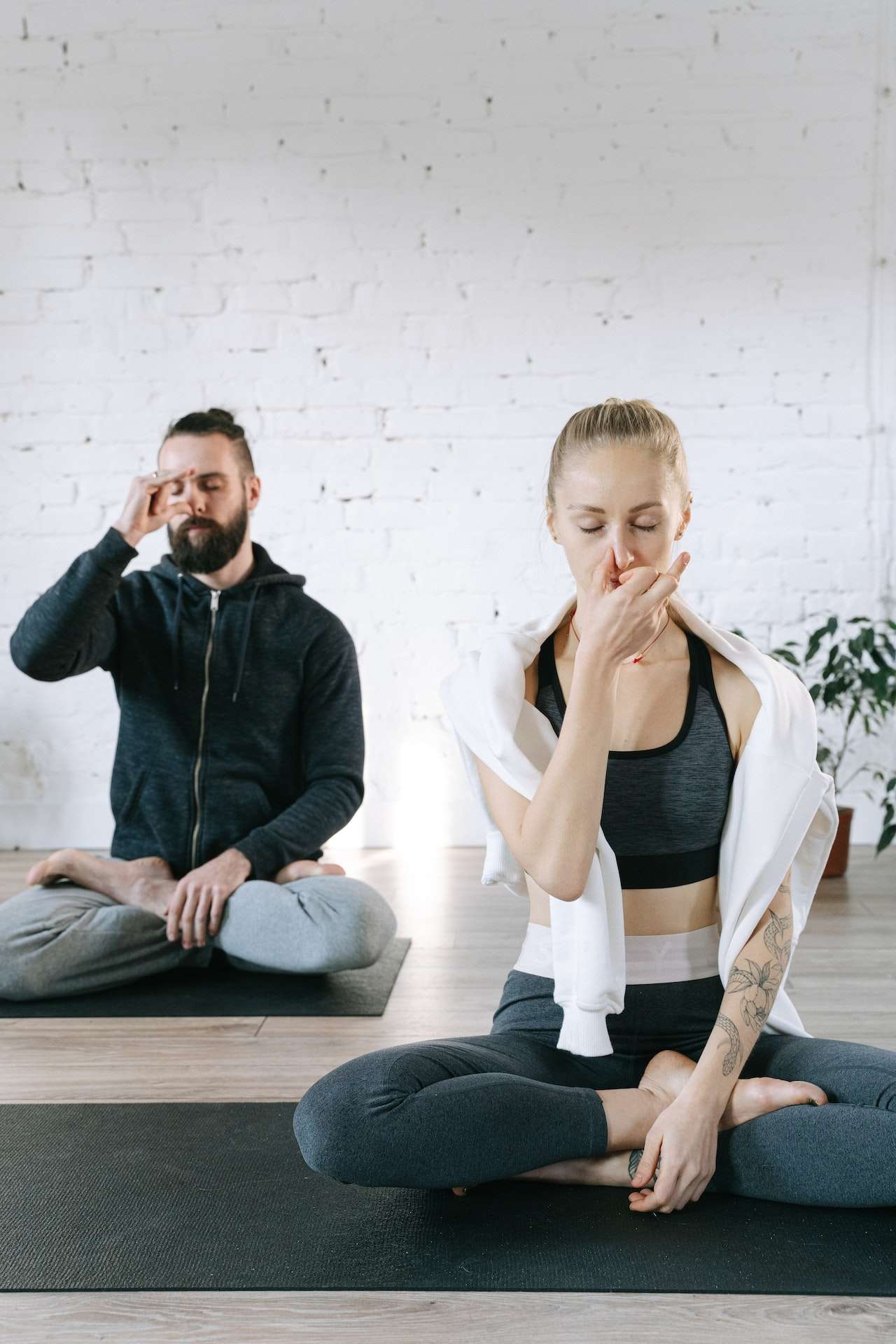 A Man and a Woman Meditating Practicing Breathing Control 