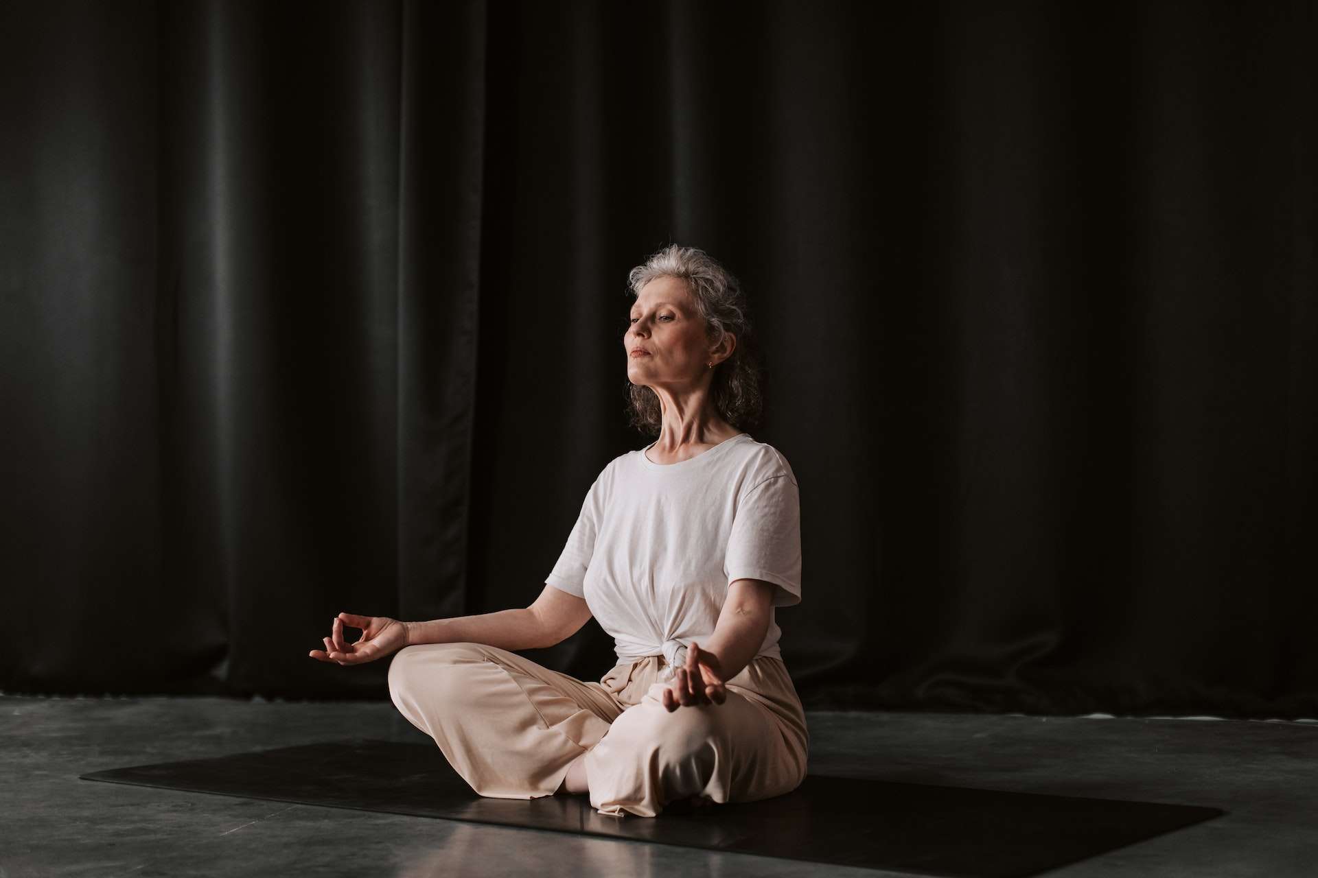 An Elderly Woman Meditating with Aakash Mudra Hand Position 