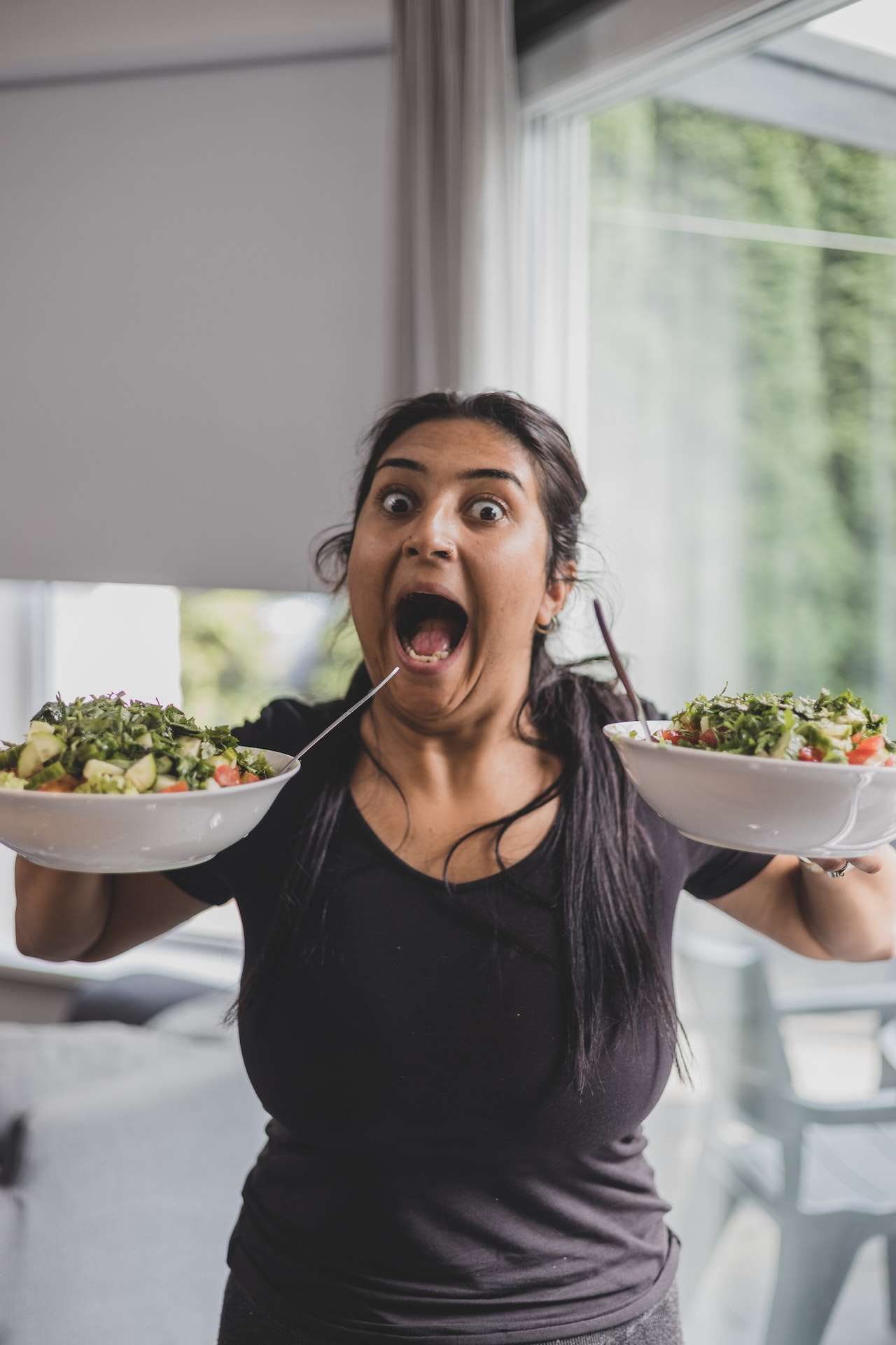 Funny Woman with Plates with Salad for weight loss journey