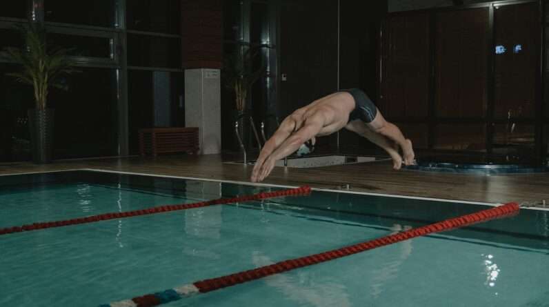 Man in Black Trunks Diving in the Swimming Pool