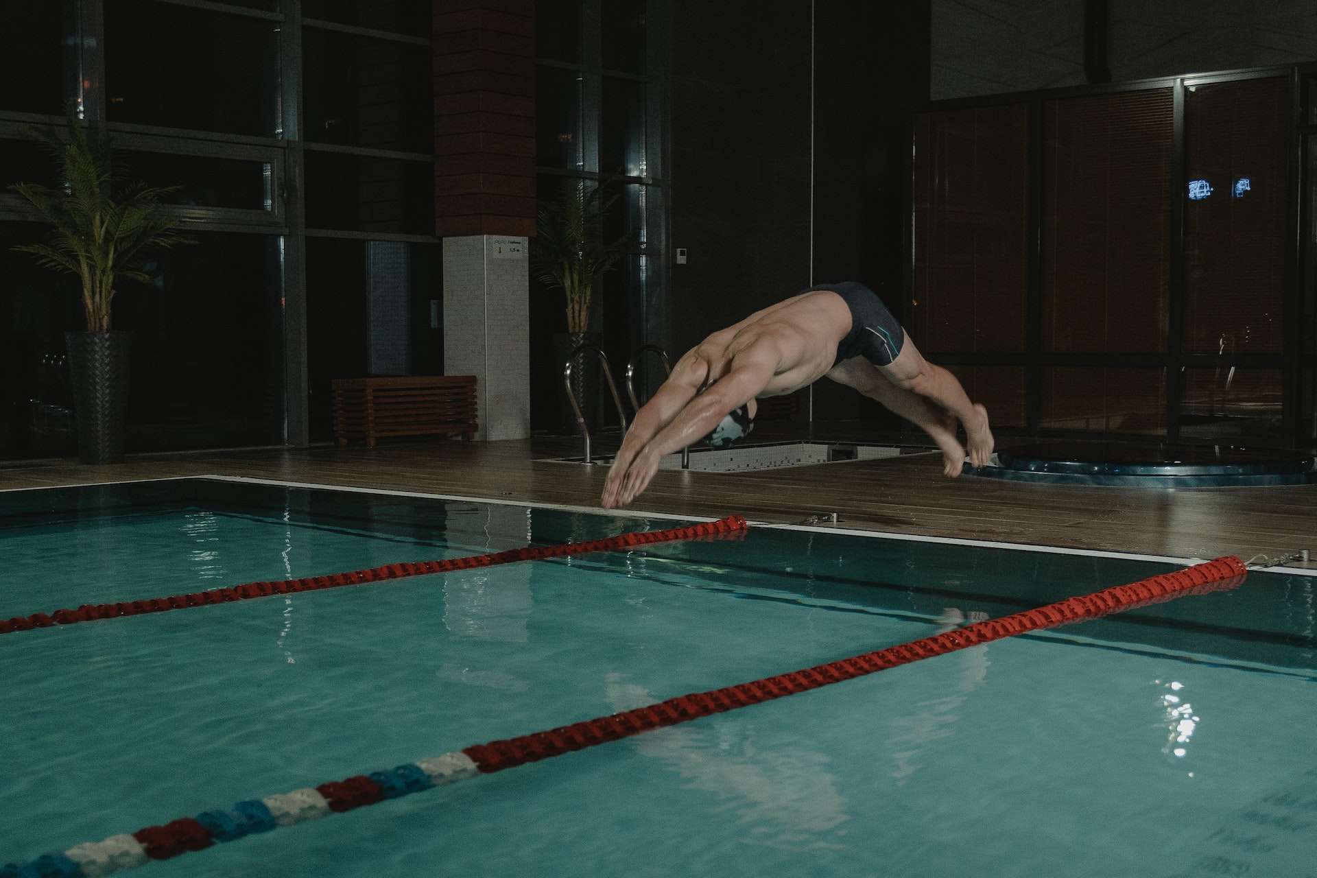 Man in Black Trunks Diving in the Swimming Pool