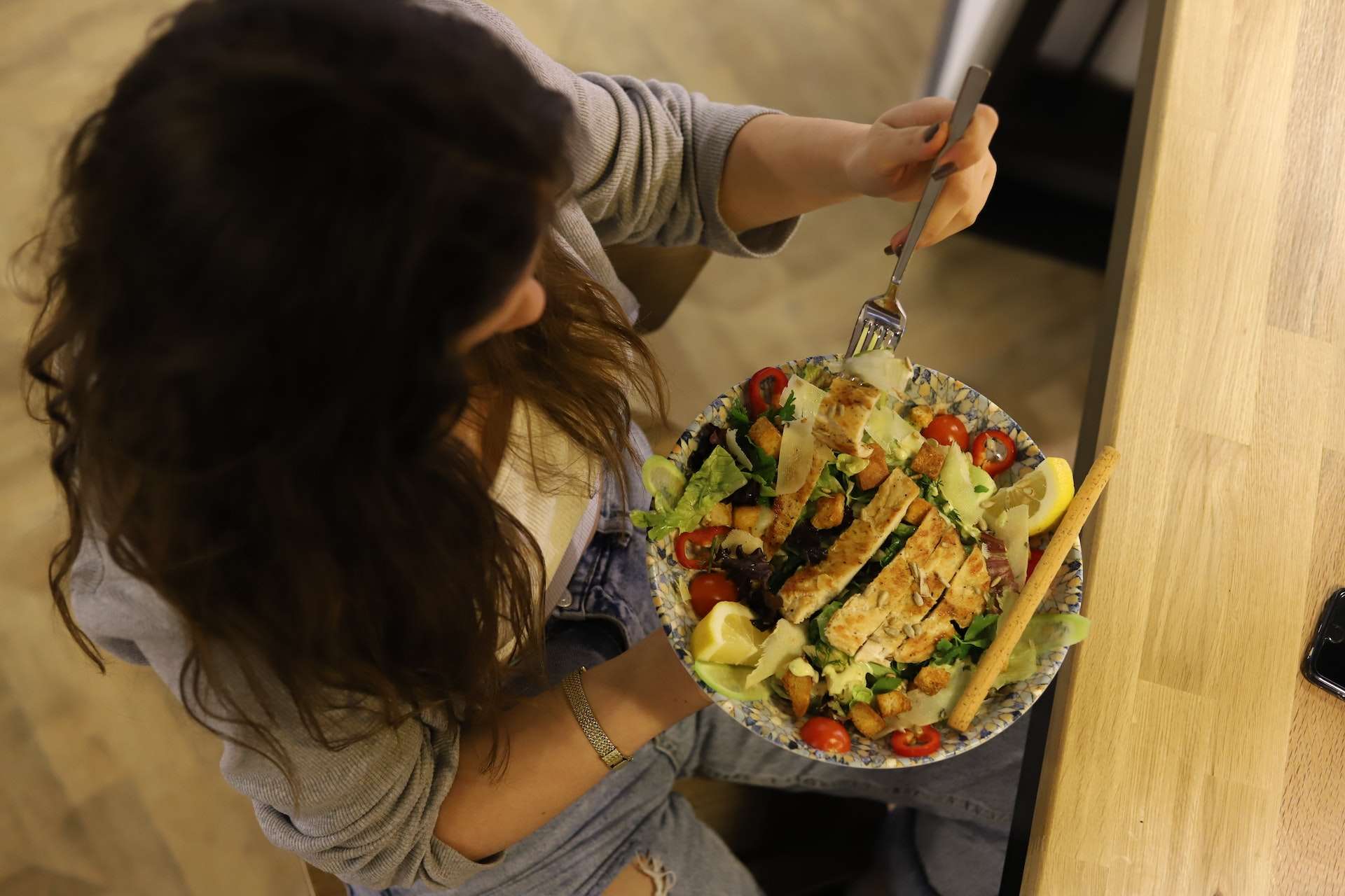 Overhead Shot of a Woman Eating a Salad 