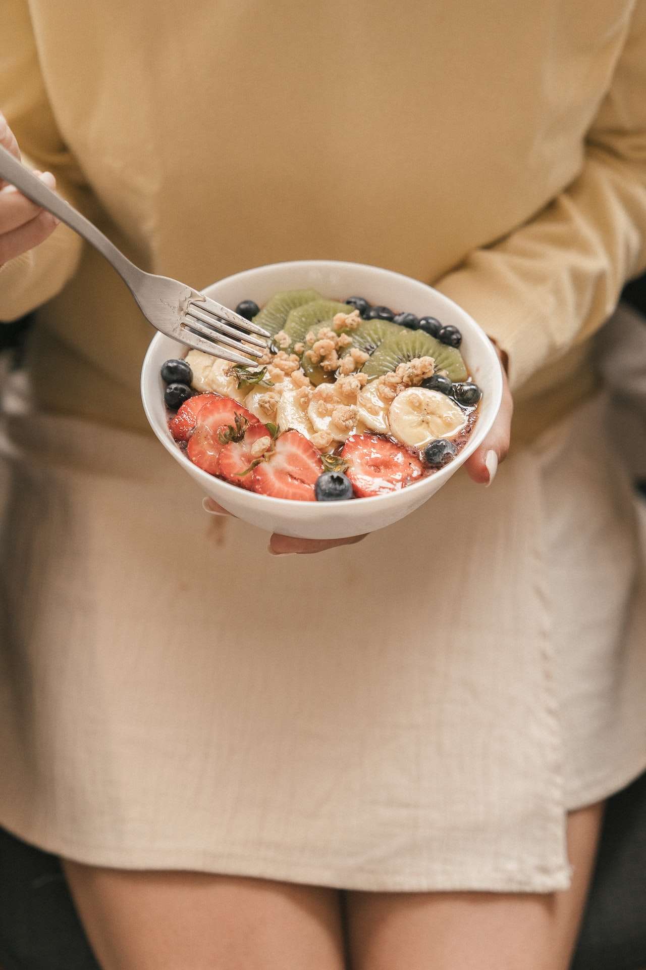 Person Holding White Ceramic Bowl with Fruit Salad