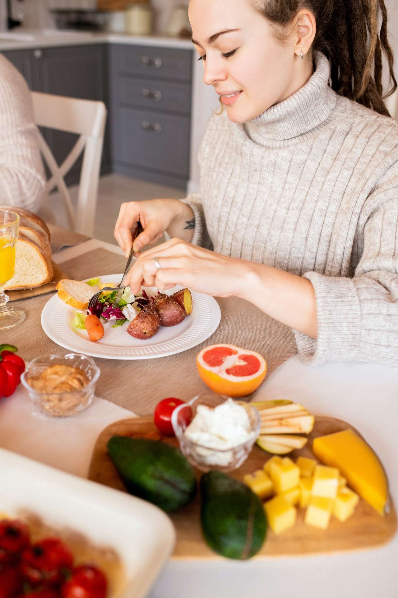 Woman In A Sweater Eating fruits
