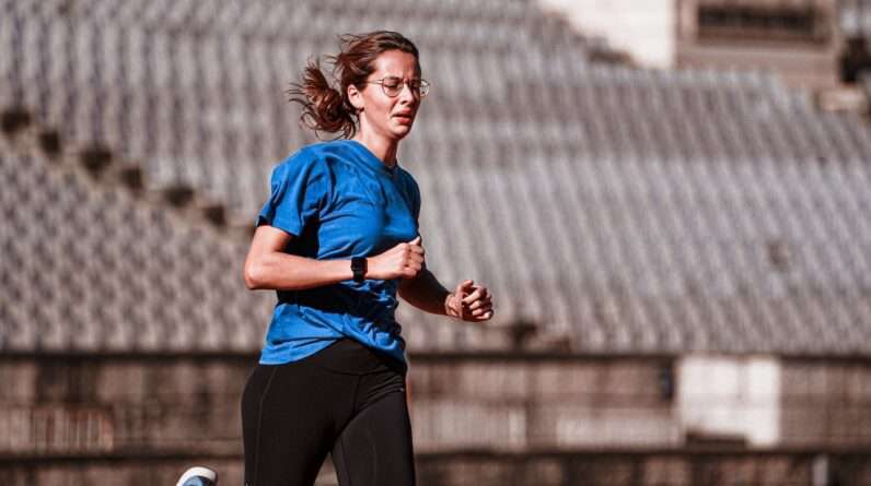 Woman Running on a Running Track