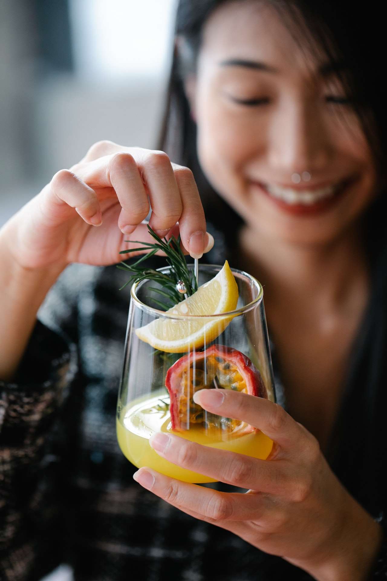 Woman Stirring Her Fruity Drink 