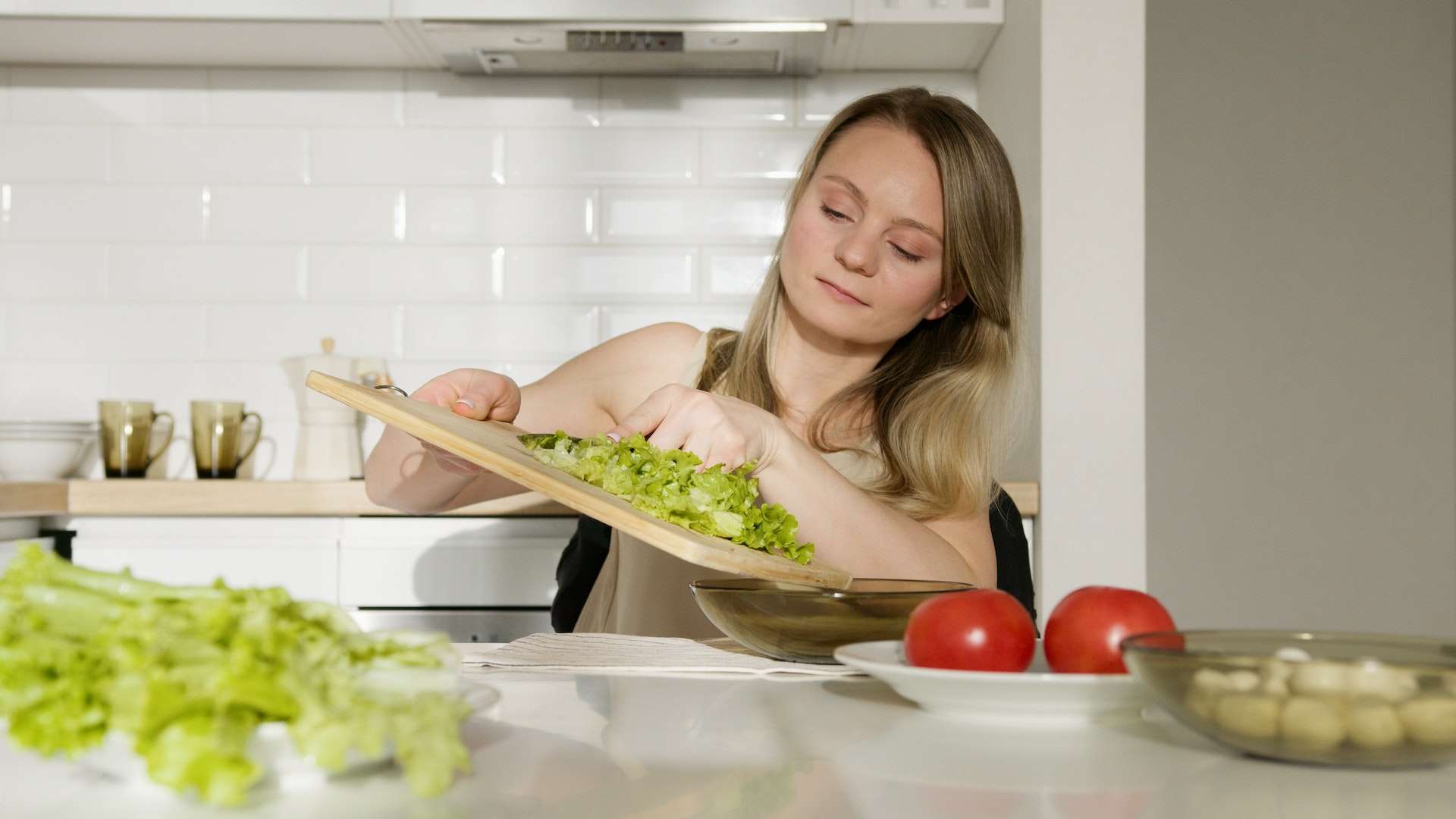 Woman in Green Tank Top making vegetarian salad
