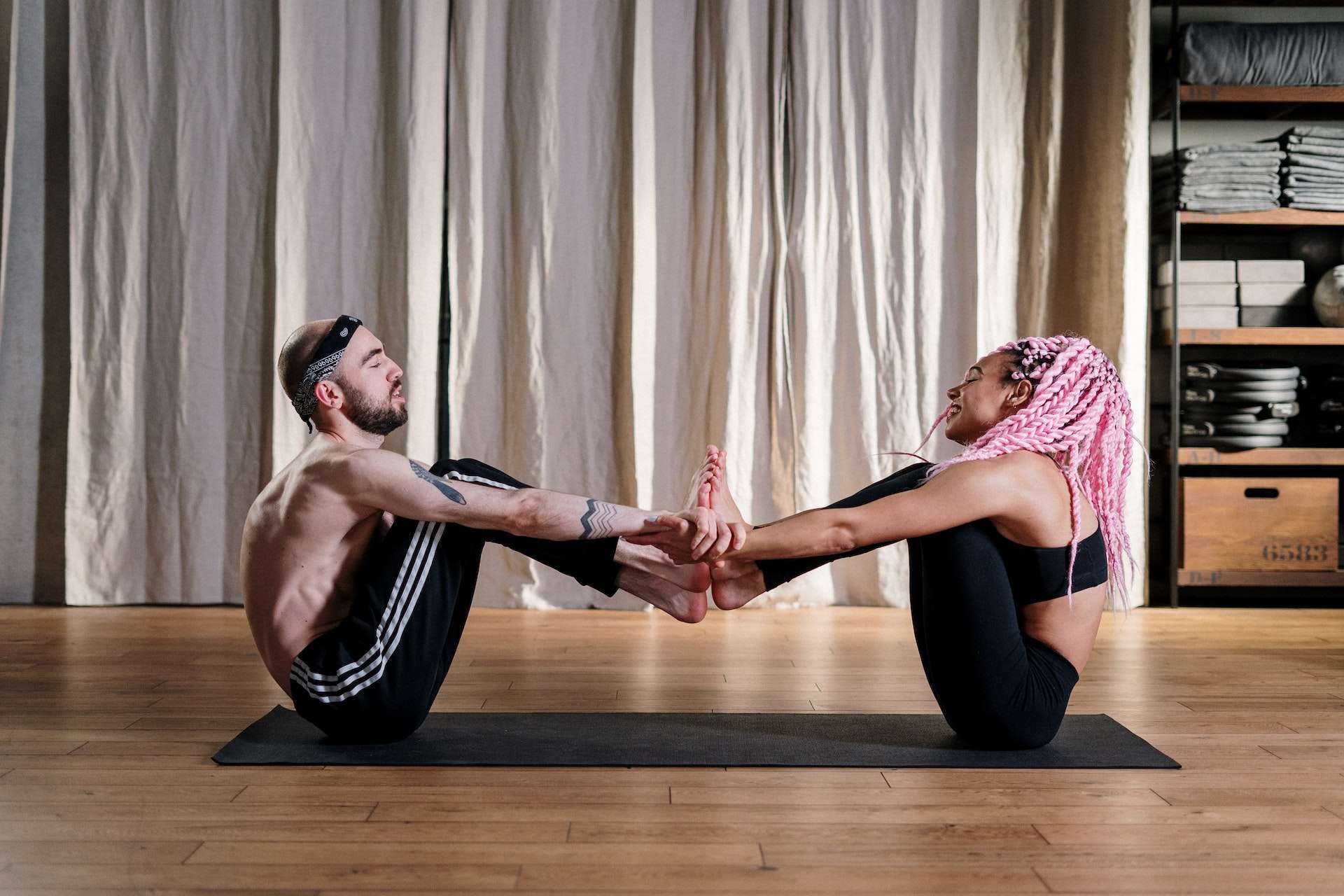 Woman in Pink Tank Top and Black Leggings Doing Yoga 