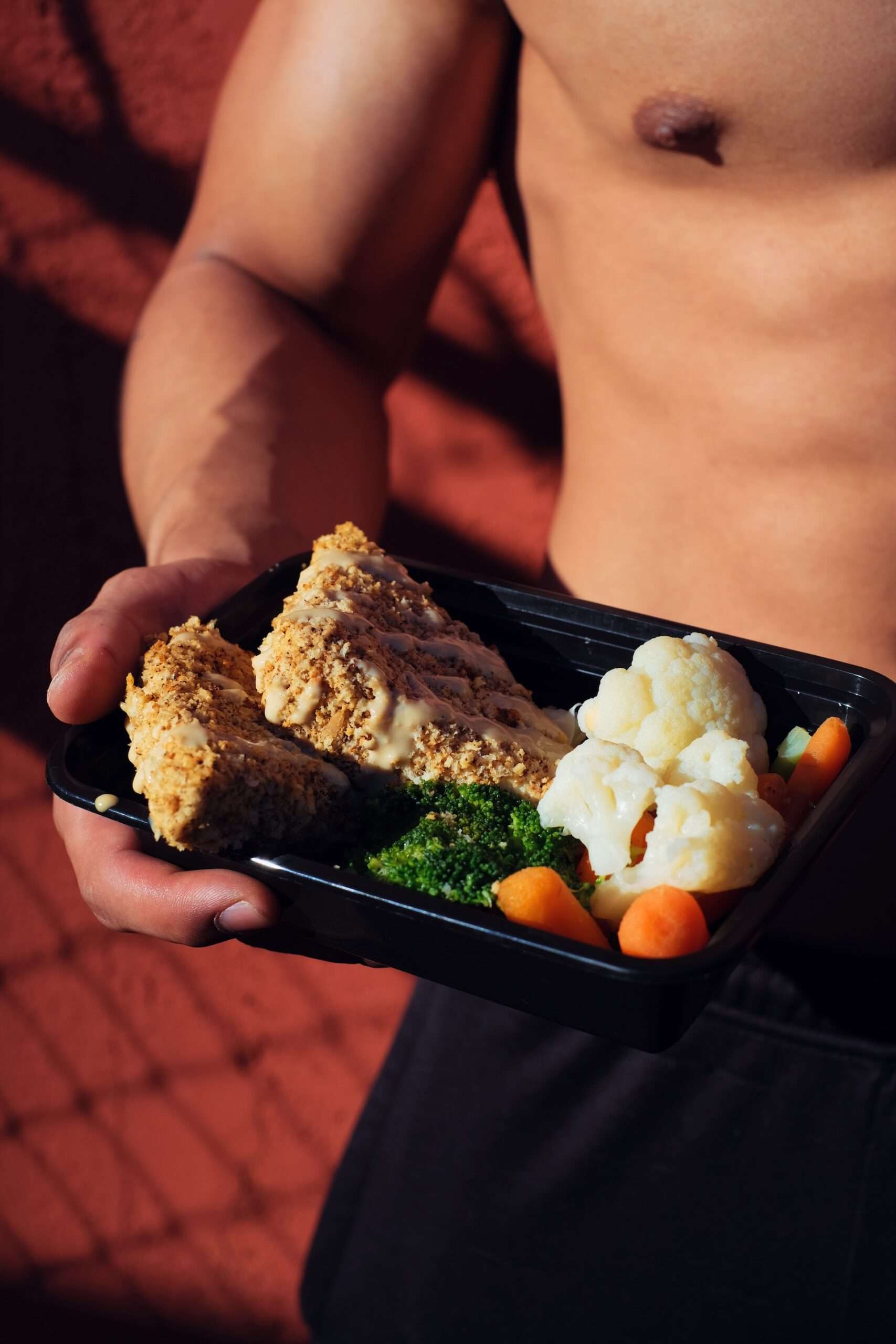 a person holding a healthy meal for his diet