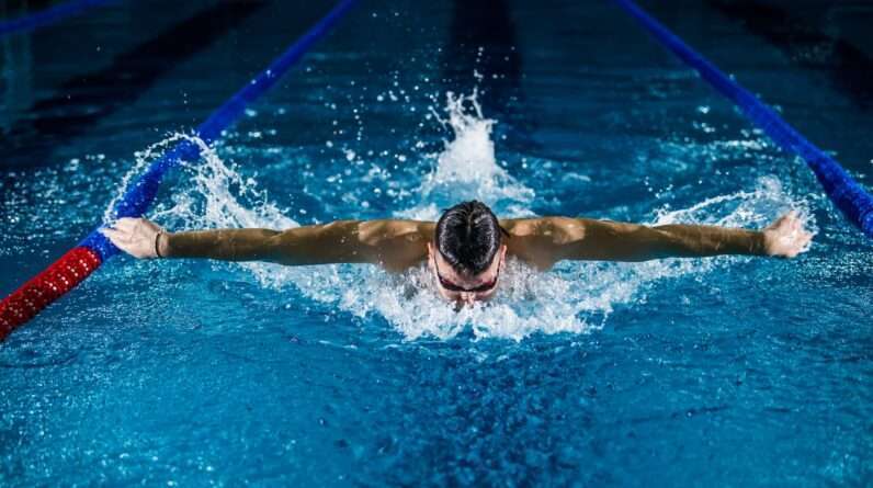 man swimming and doing butterfly stroke
