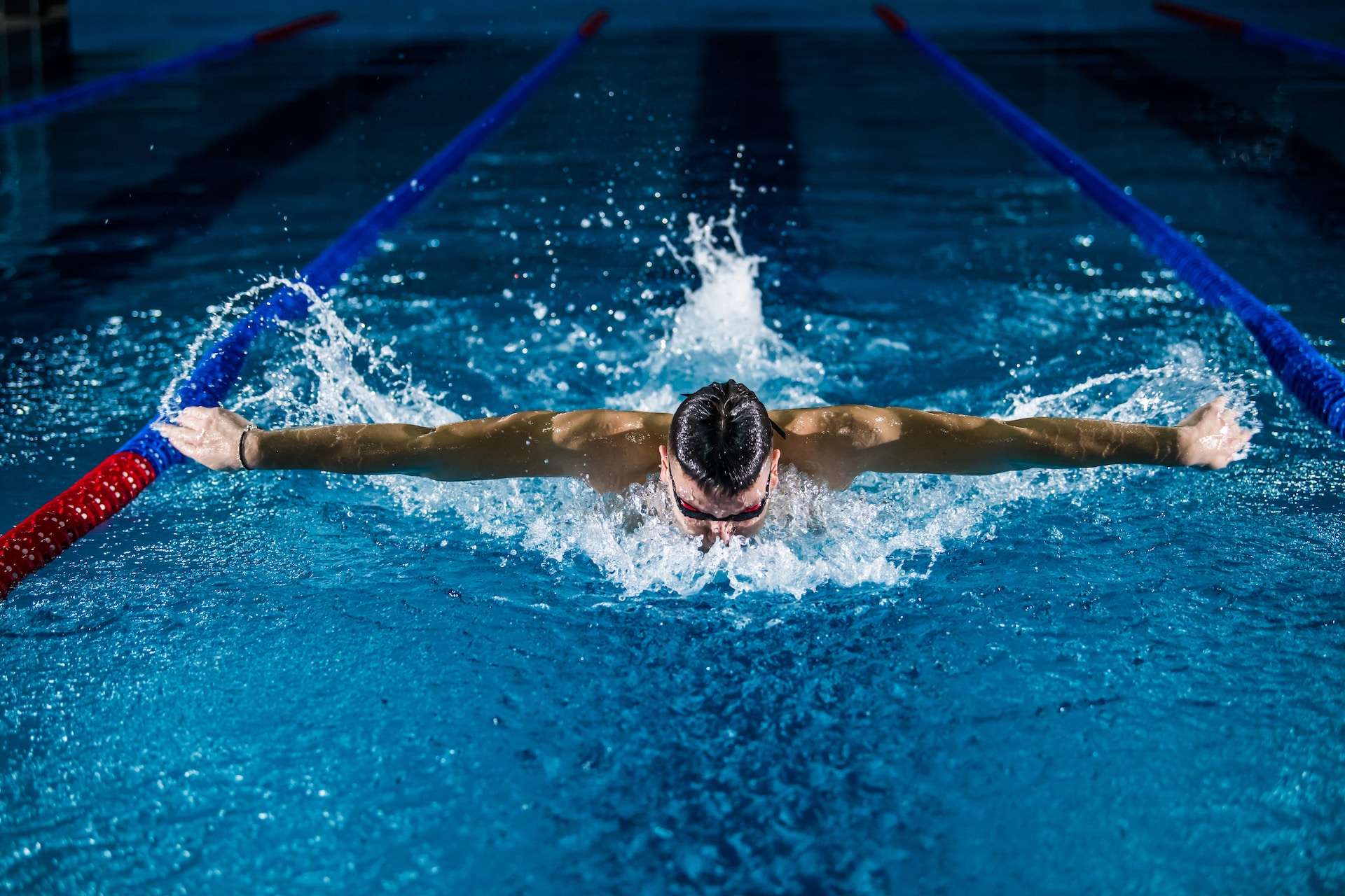 man swimming and doing butterfly stroke