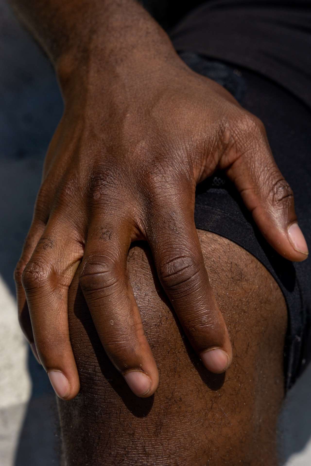 A Person's Hand on His Knee
