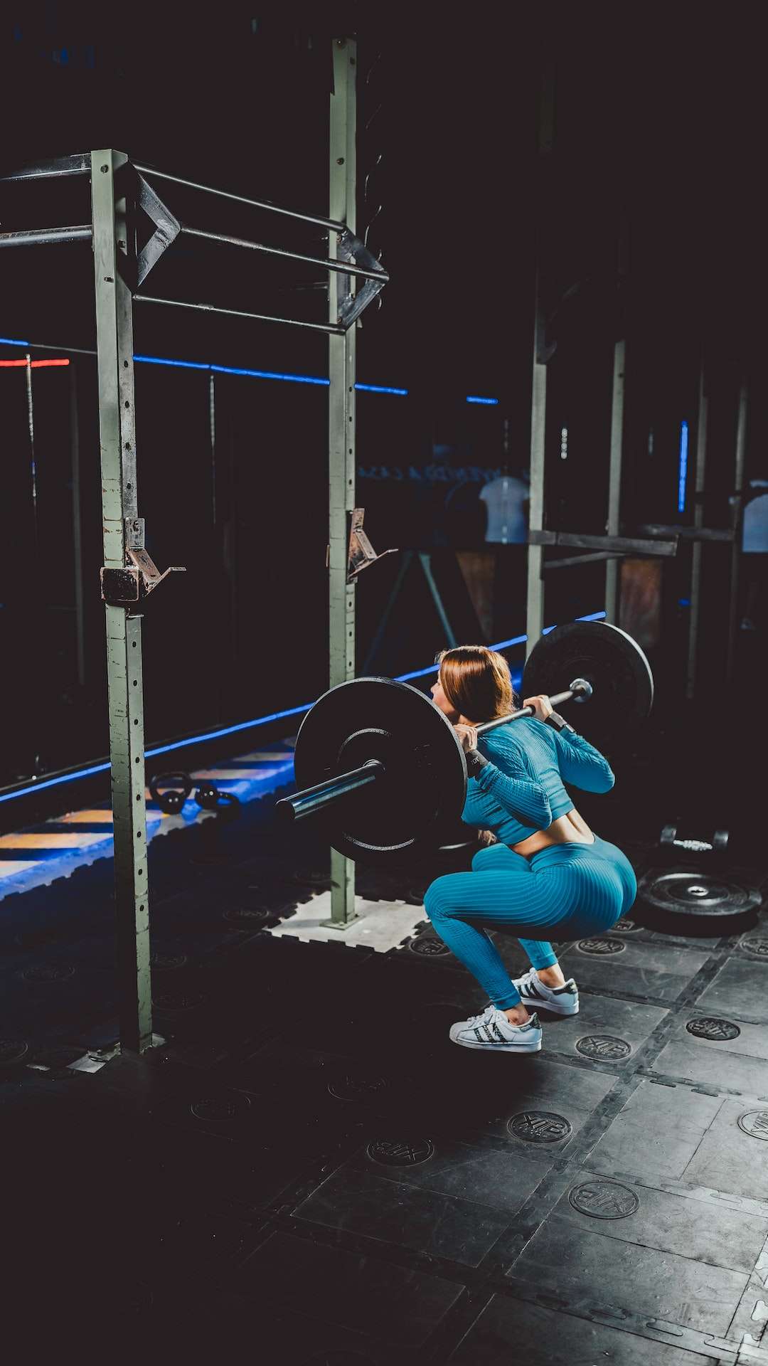 A Woman Doing Squats at the Gym 