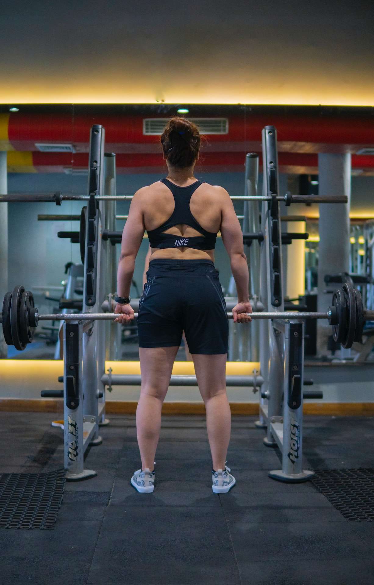 A Woman Lifting Weights in a Gym 