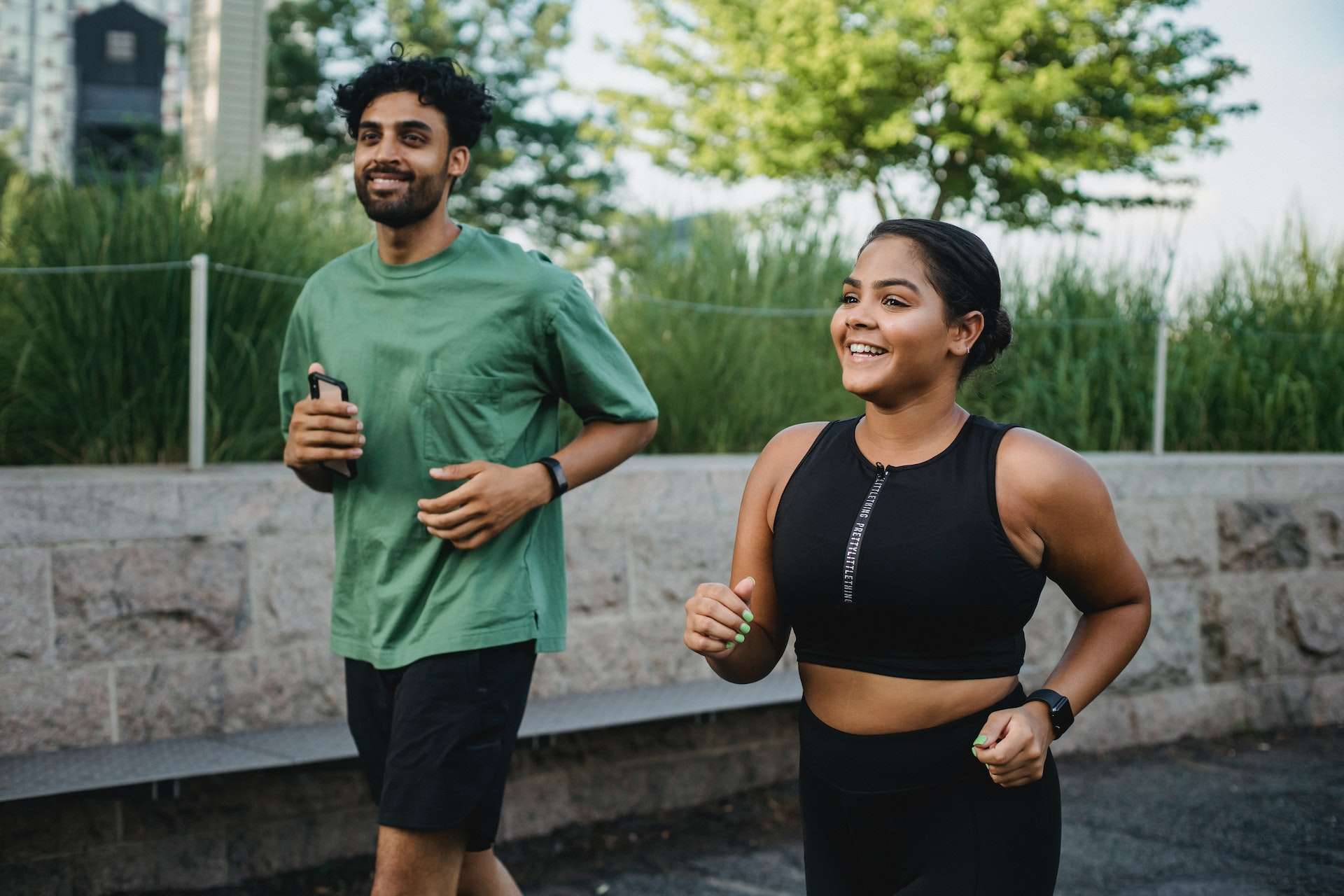 Man and Woman Smiling While Jogging Together