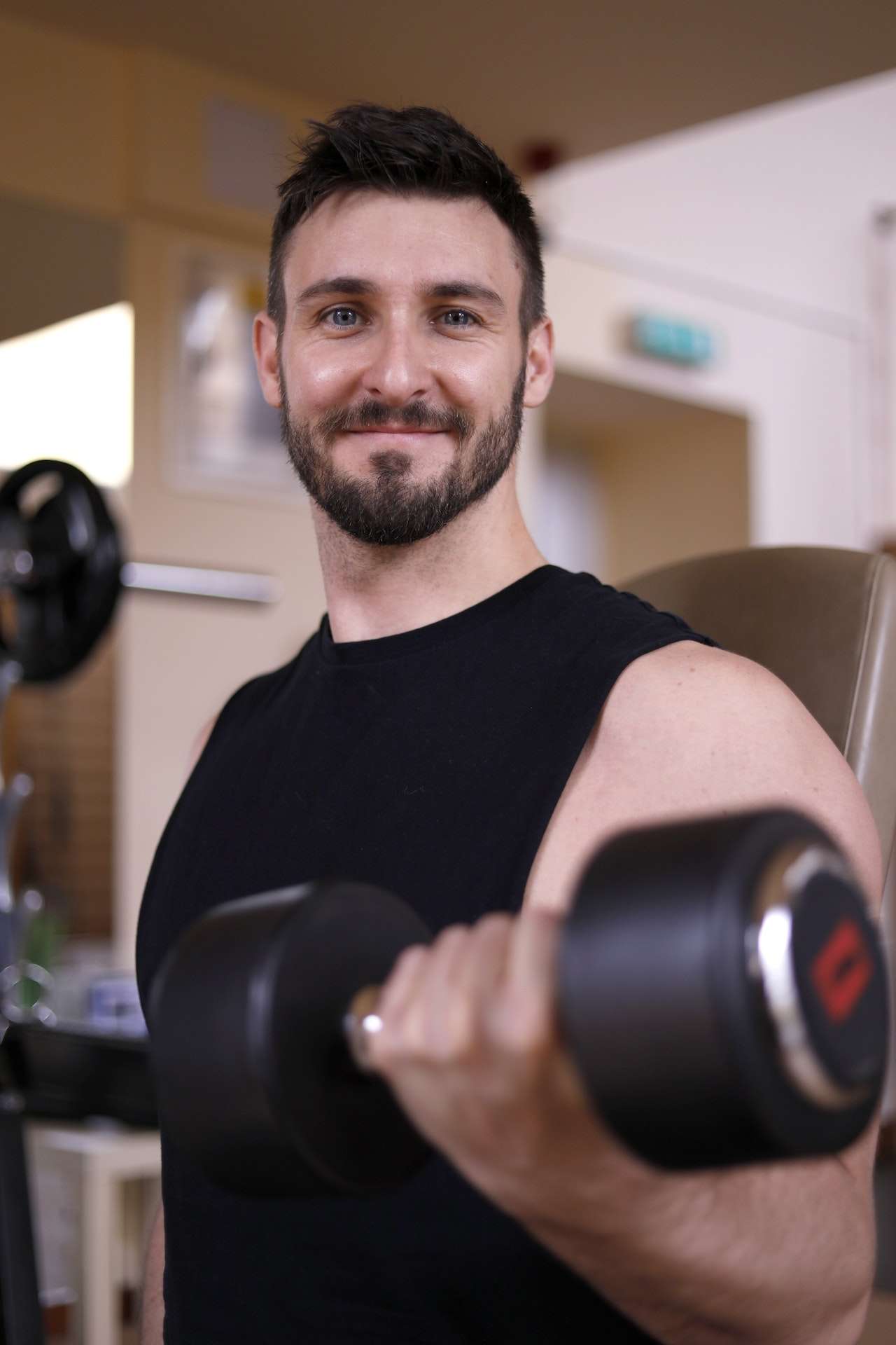 Man in Black Crew Neck T-shirt Holding A Dumbbell 