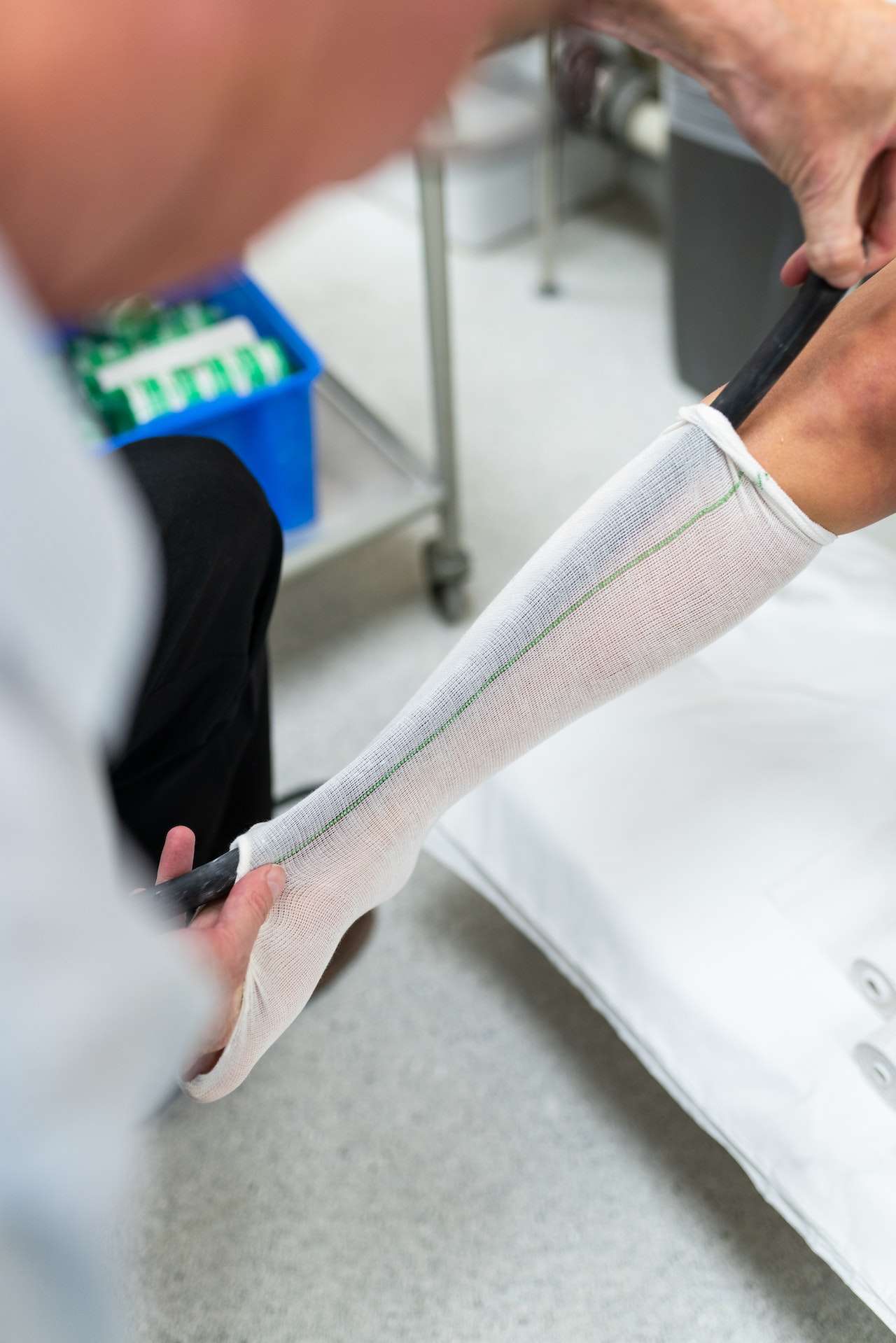 Person Measuring Patient Leg

