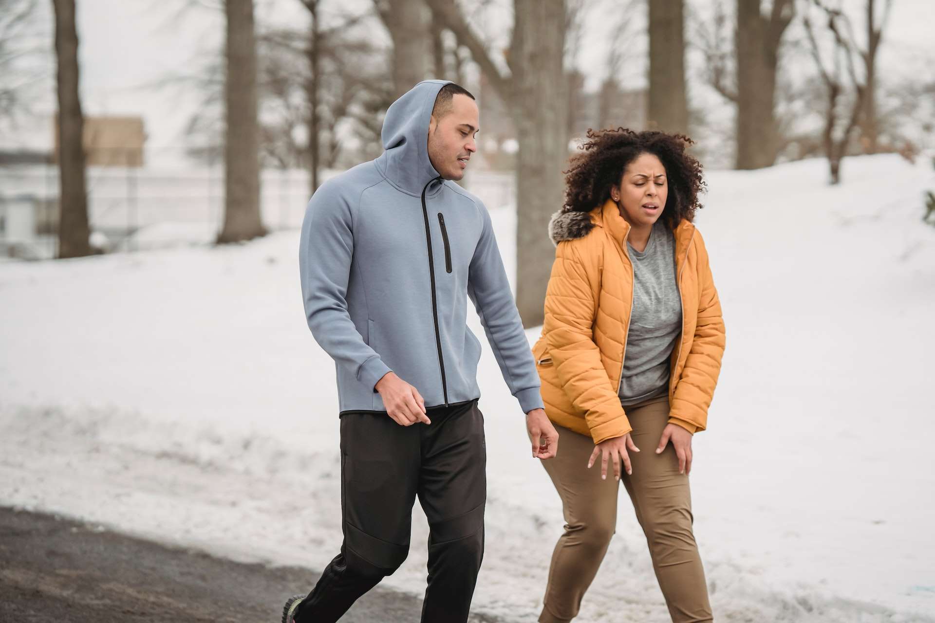 Tired overweight black woman with trainer during training 